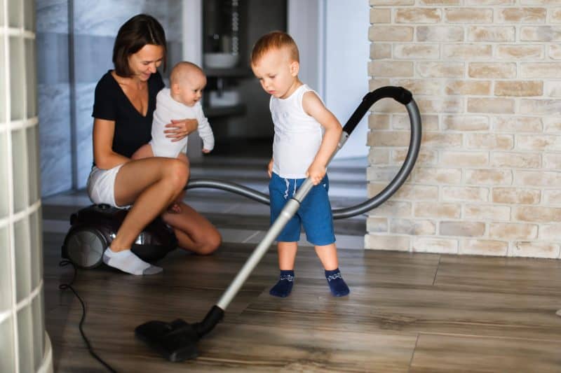 mom-and-children-are-cleaning-up-son-vacuums-floor-ทำความสะอาดห้อง